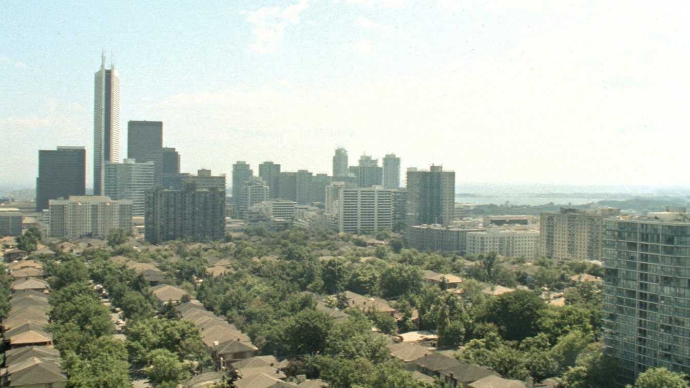 Aerial view of west Toronto neighbourhoods toward Lake Ontario (illustrative)