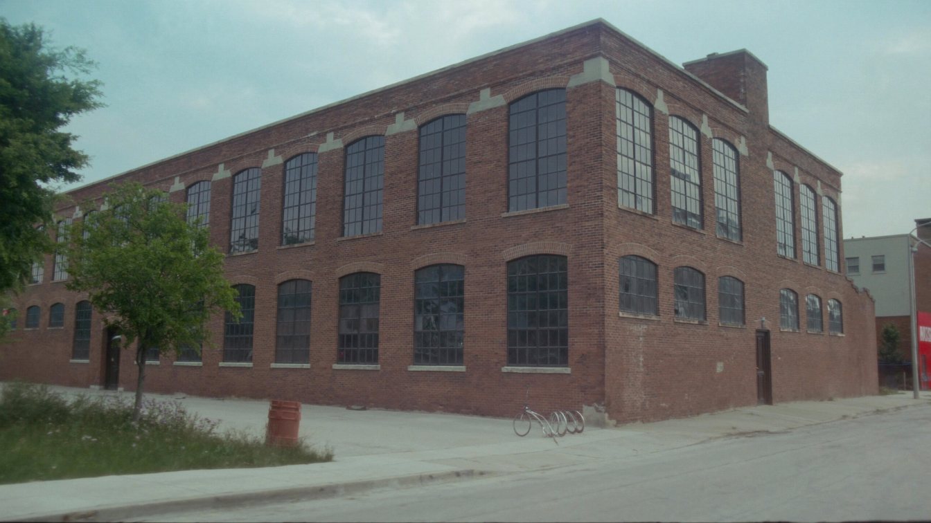 Converted brick industrial building with large factory windows on a Liberty Village street in Toronto (illustrative)